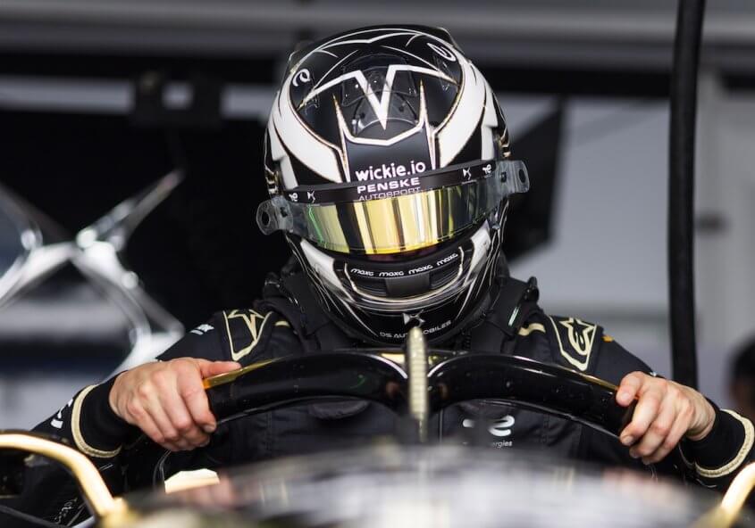 Maximilian Günther climbing into his DS PENKSE Formula E car, wearing his Wickie.io-branded helmet